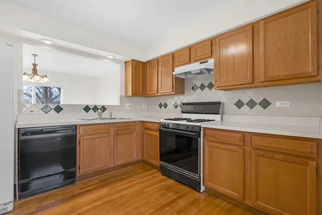 a kitchen with stainless steel appliances granite countertop a stove and a sink