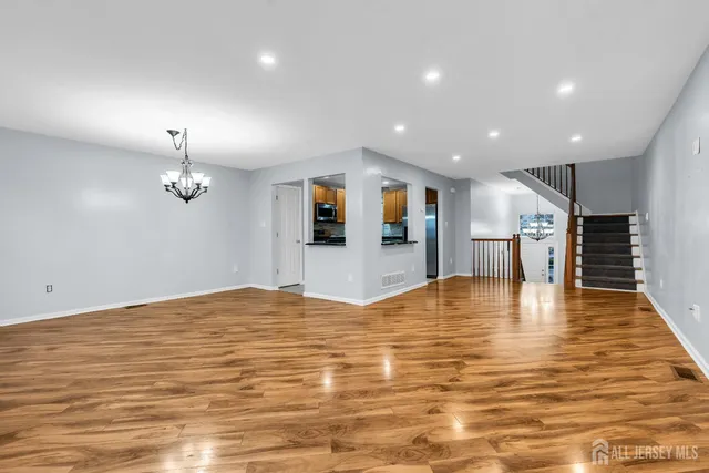 a living room with furniture a dining table and a potted plant