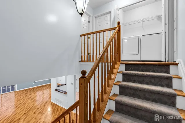 a bedroom with a large bed and a chandelier fan