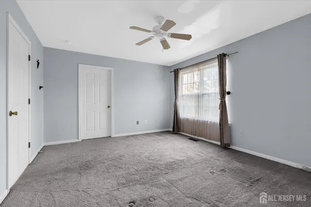 a bedroom with bed and window