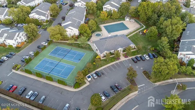 an aerial view of a house with a lake view and a big yard