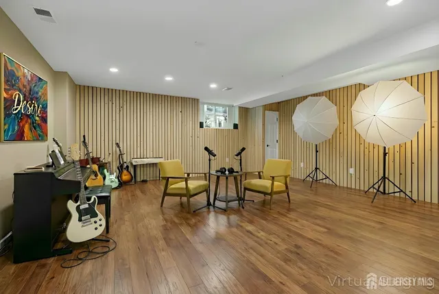 a living room with furniture a rug and a flat screen tv