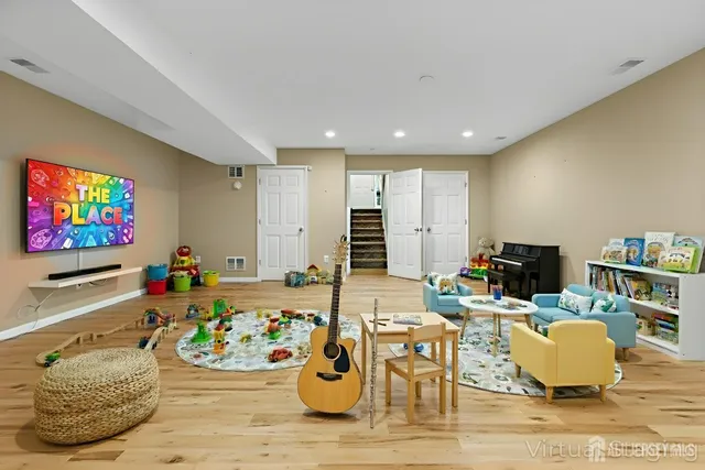 a living room with furniture and painting on the wall