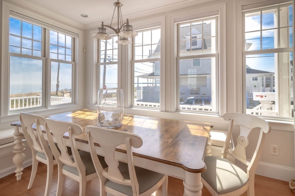 73 K Street Hull, MA 02045 - Photo 12 of 42 a view of a dining room with furniture large windows and wooden floor