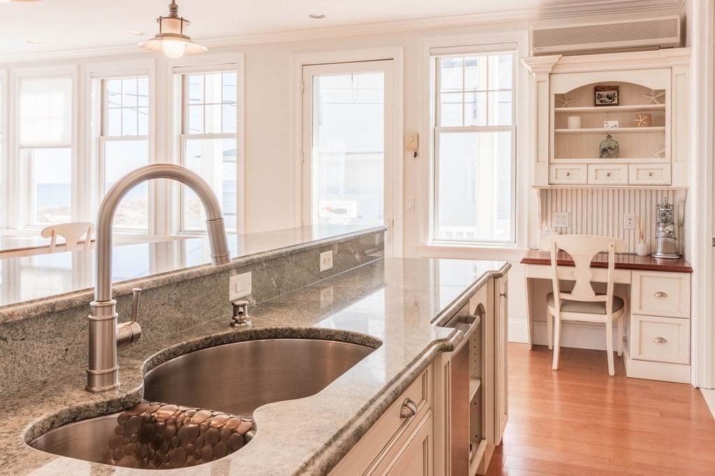 73 K Street Hull, MA 02045 - Photo 15 of 42 a kitchen with granite countertop a sink and a window