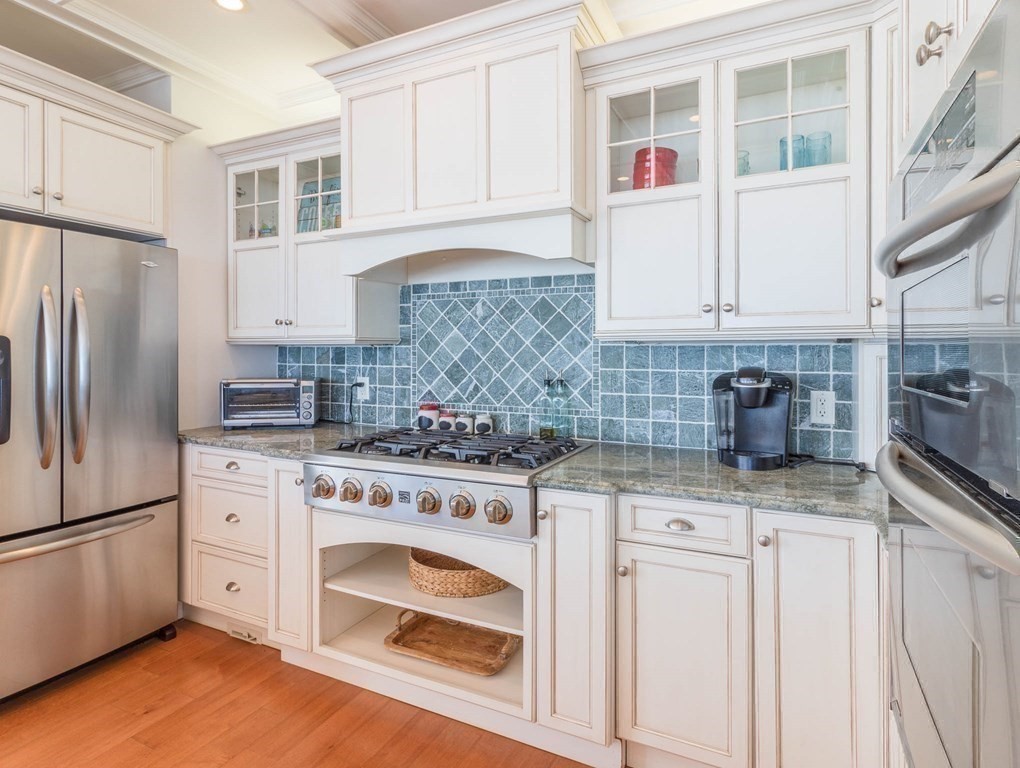 73 K Street Hull, MA 02045 - Photo 16 of 42 a kitchen with granite countertop a sink stainless steel appliances and cabinets