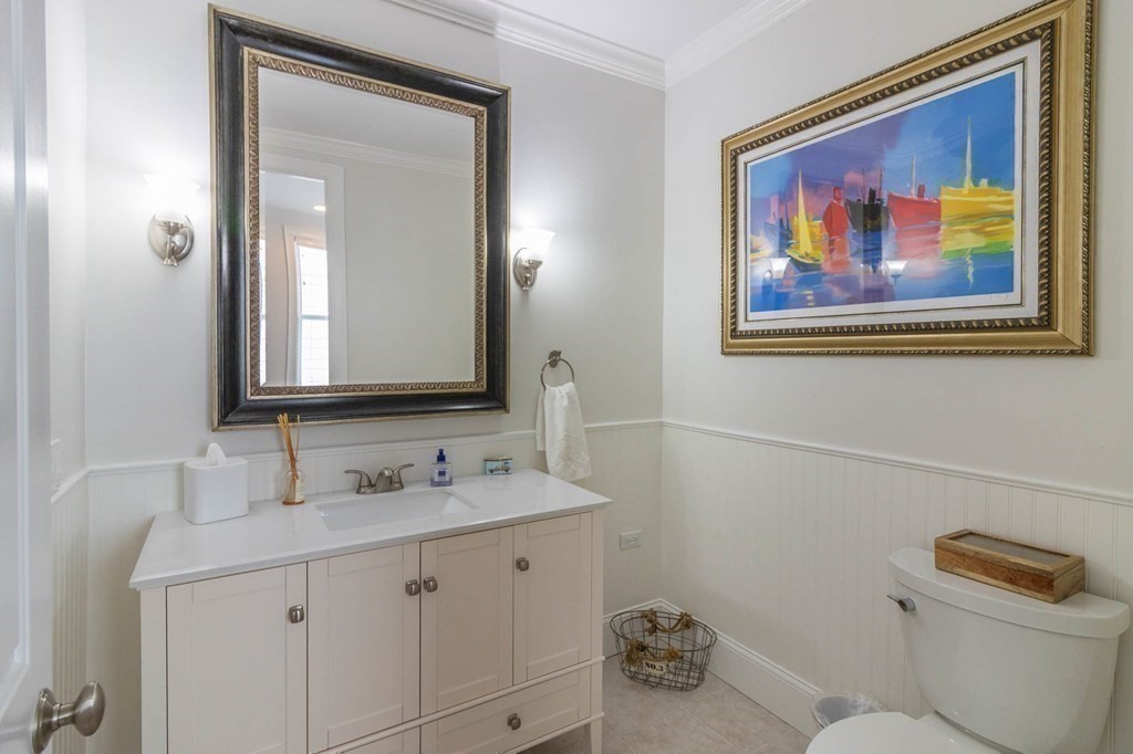 73 K Street Hull, MA 02045 - Photo 18 of 42 a bathroom with a toilet a sink and mirror