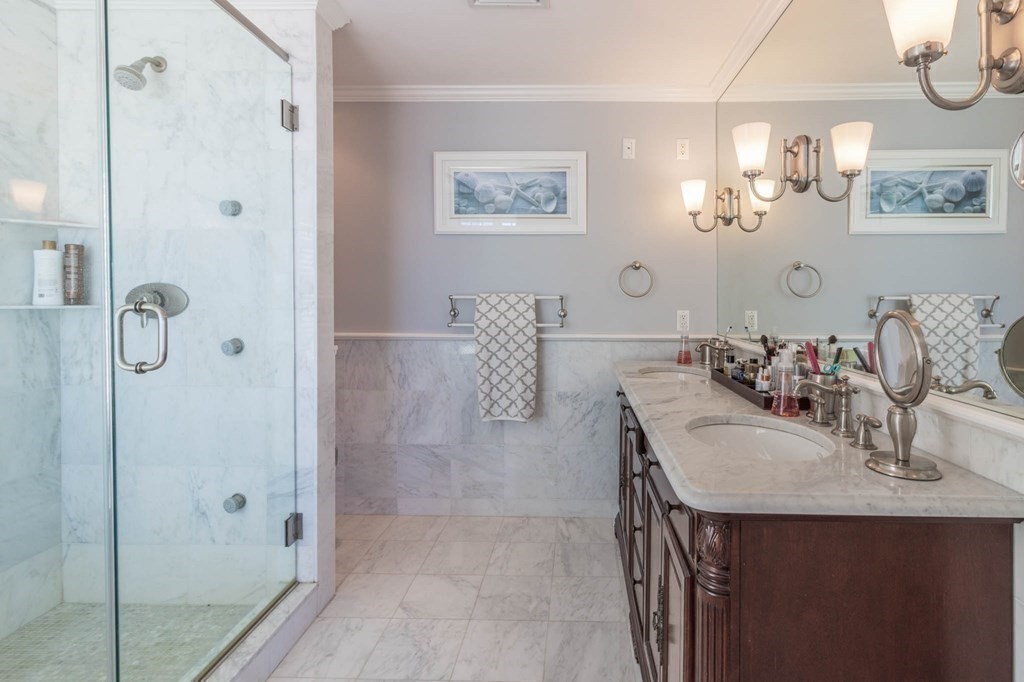 73 K Street Hull, MA 02045 - Photo 21 of 42 a bathroom with a sink double vanity and shower