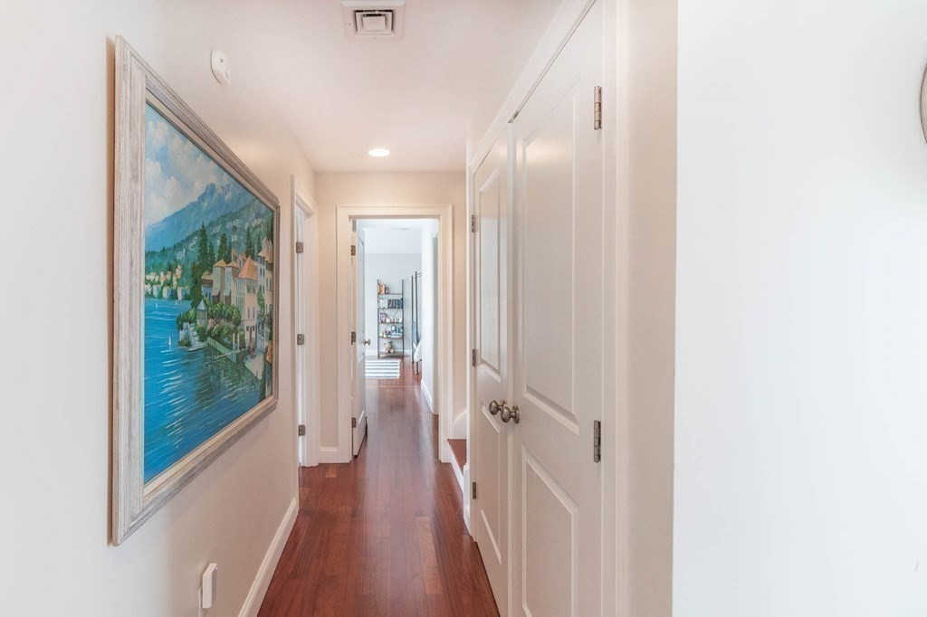 73 K Street Hull, MA 02045 - Photo 24 of 42 a view of a hallway with wooden floor and a bathroom
