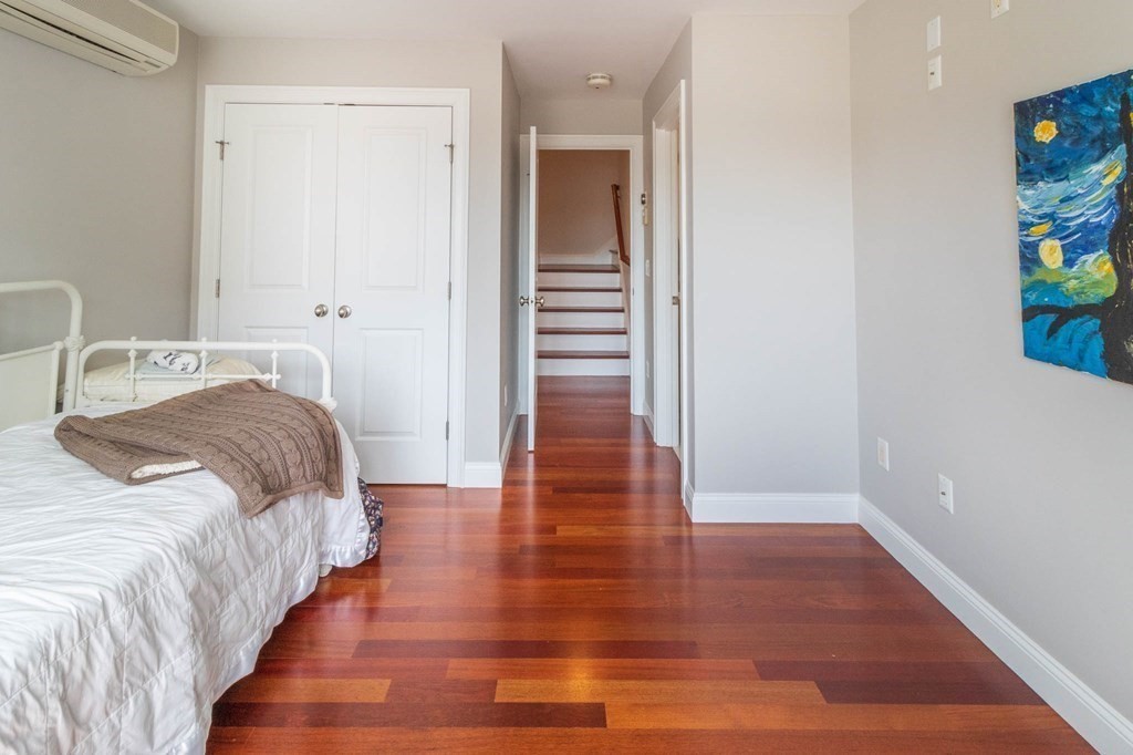 73 K Street Hull, MA 02045 - Photo 28 of 42 a bedroom with double bed and wooden floor