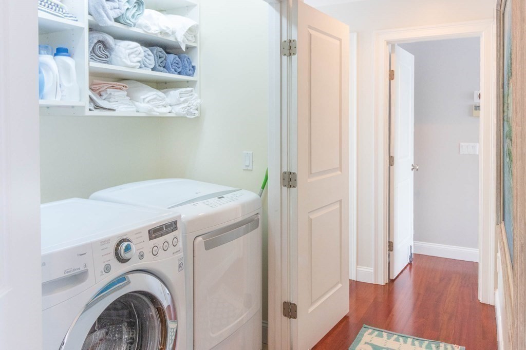 73 K Street Hull, MA 02045 - Photo 31 of 42 a view of washer and dryer with wooden floor