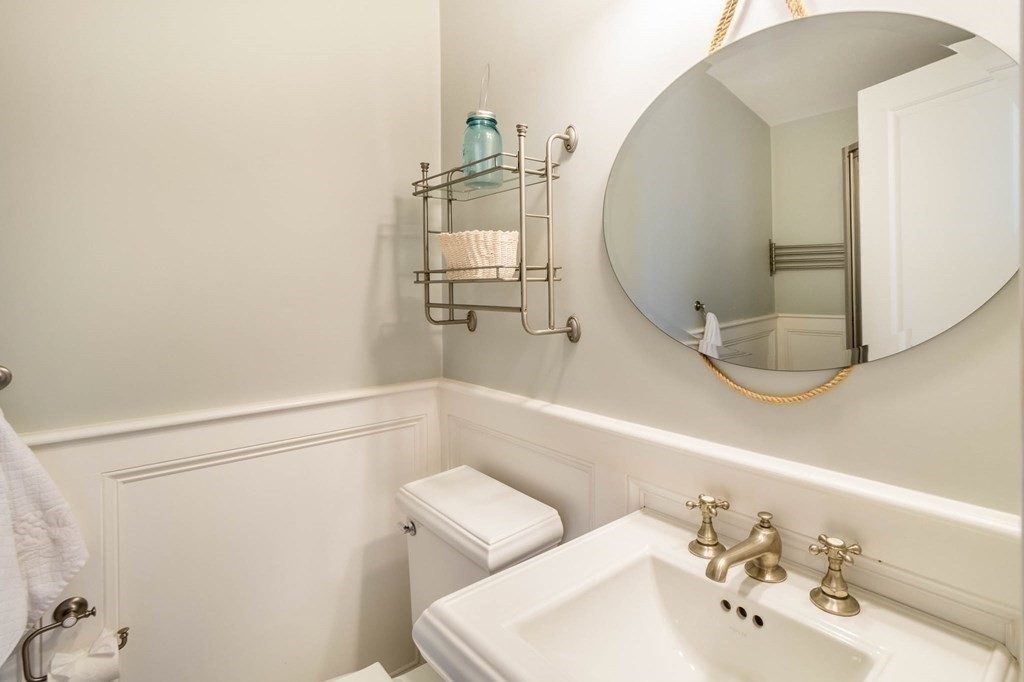 73 K Street Hull, MA 02045 - Photo 35 of 42 a bathroom with a sink and mirror with toilet
