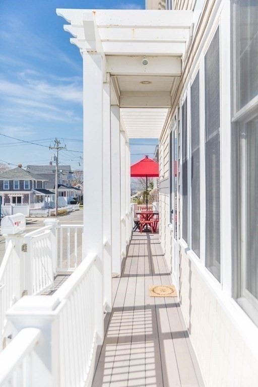 73 K Street Hull, MA 02045 - Photo 39 of 42 a room with painting on the wall and a floor to ceiling window