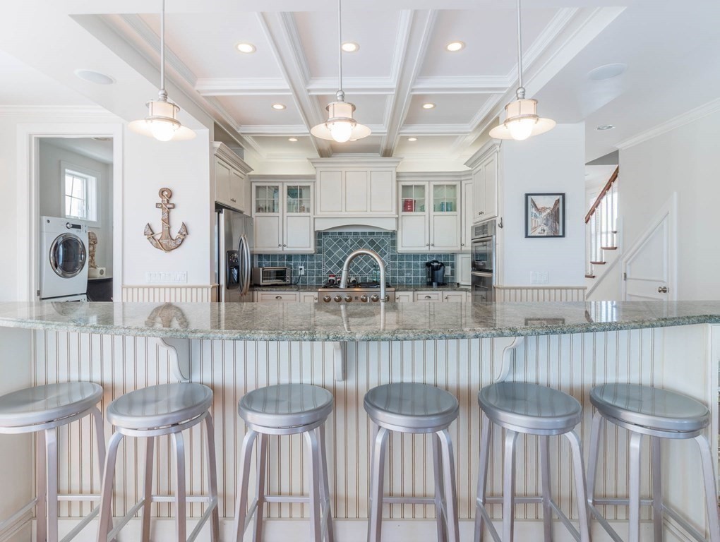 73 K Street Hull, MA 02045 - Photo 9 of 42 a kitchen with lots of counter space and chairs
