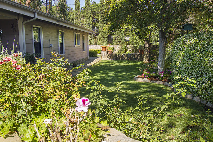 370 Gridley Road Ojai, CA 93023 - Photo 7 of 34 a backyard of a house with table and chairs and wooden fence