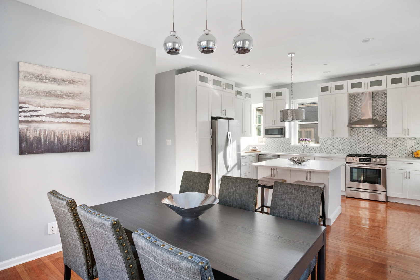 5556 North Wayne Avenue Chicago, IL 60640 - Photo 11 of 37 a living room with stainless steel appliances furniture a dining table and chairs