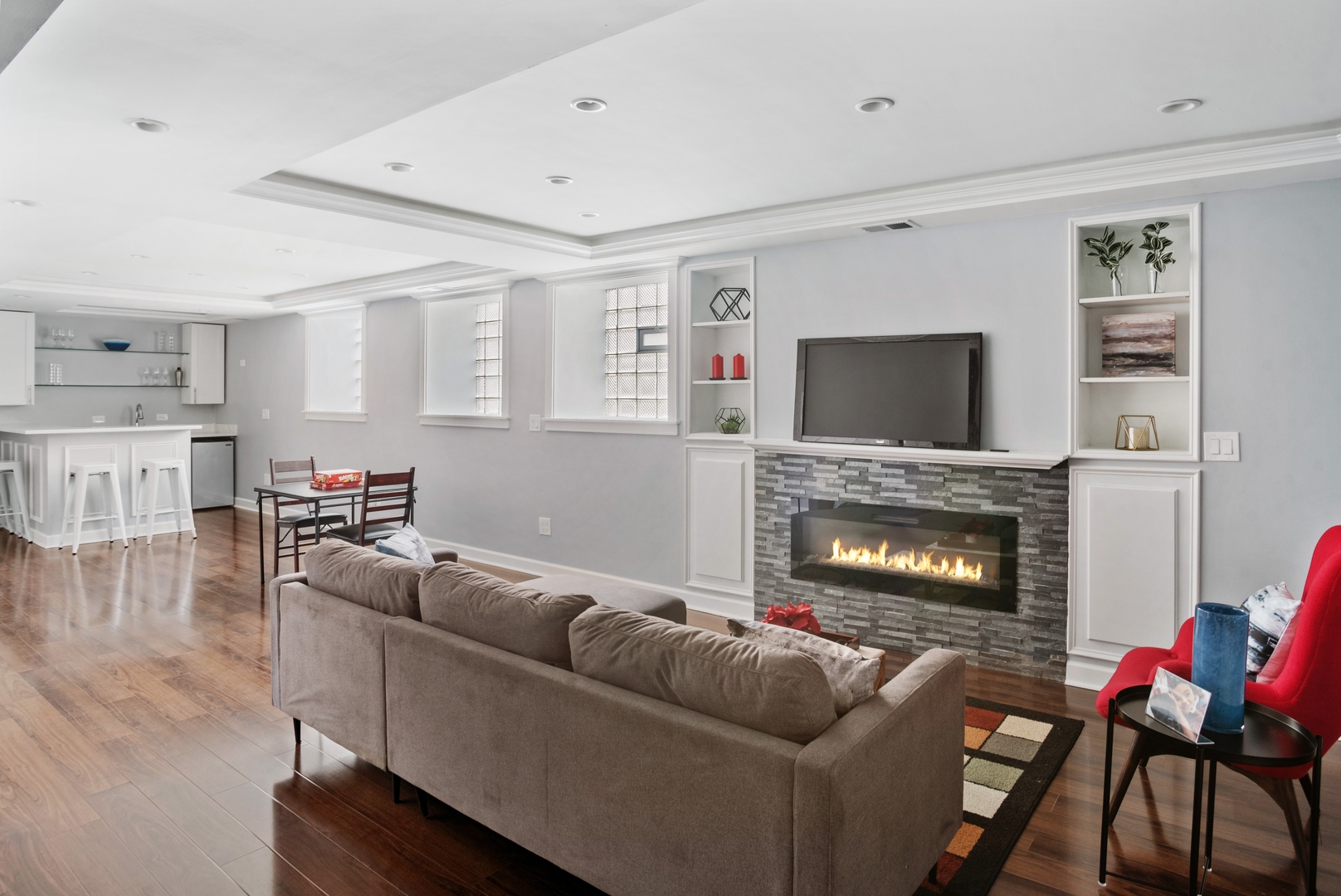 5556 North Wayne Avenue Chicago, IL 60640 - Photo 20 of 37 a living room with furniture a flat screen tv and a fireplace