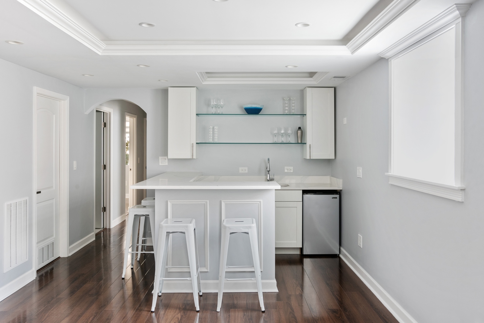5556 North Wayne Avenue Chicago, IL 60640 - Photo 23 of 37 a kitchen with kitchen island white cabinets and stainless steel appliances