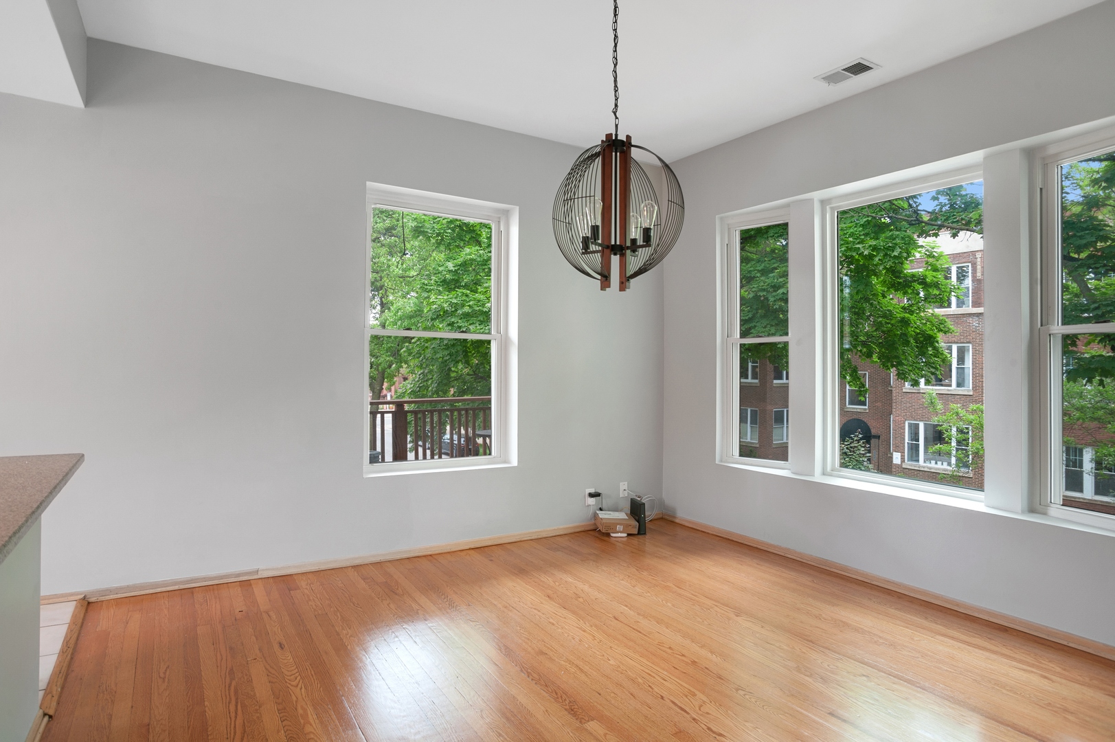 5556 North Wayne Avenue Chicago, IL 60640 - Photo 34 of 37 a view of an empty room with wooden floor and a window