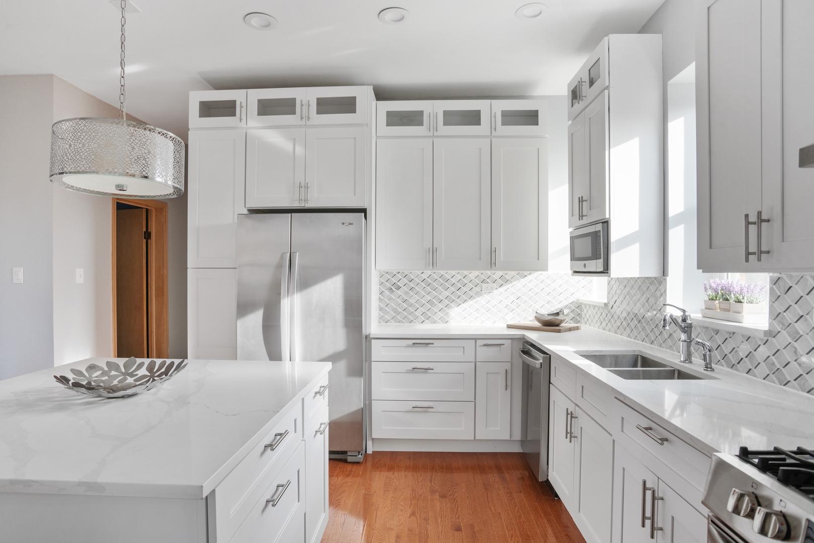 5556 North Wayne Avenue Chicago, IL 60640 - Photo 8 of 37 a spacious bathroom with a granite countertop sink and a mirror