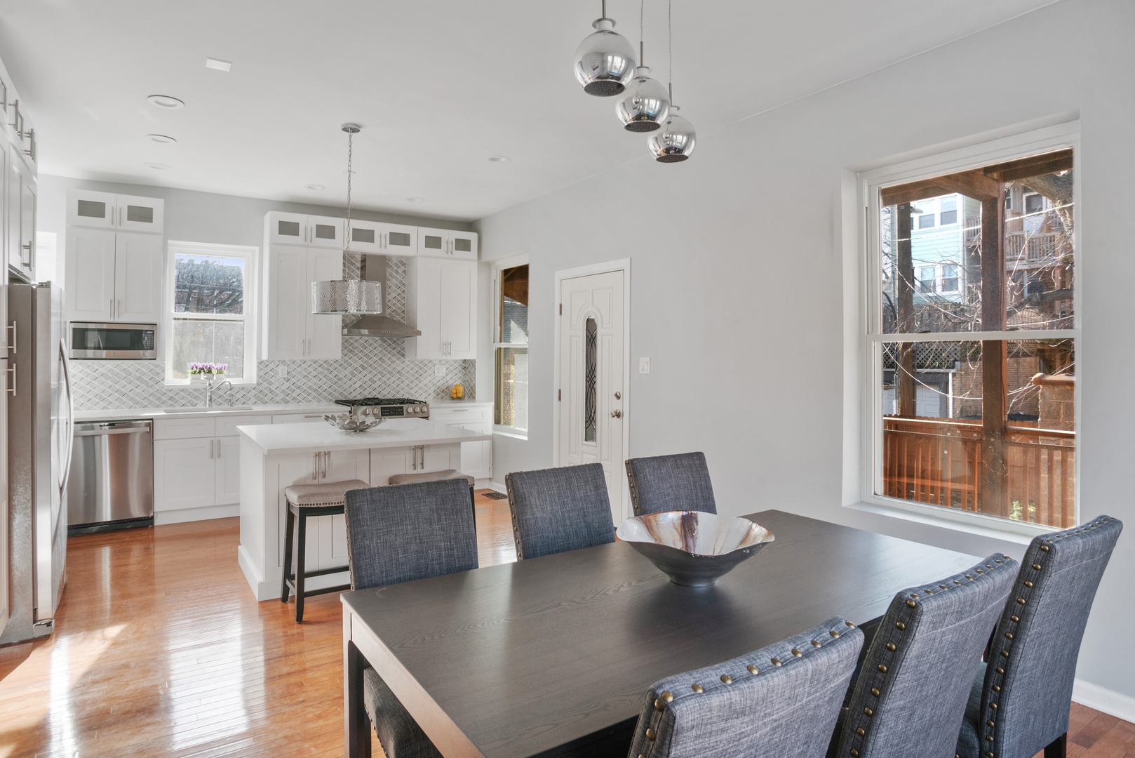 5556 North Wayne Avenue Chicago, IL 60640 - Photo 9 of 37 a view of a dining room with furniture and wooden floor