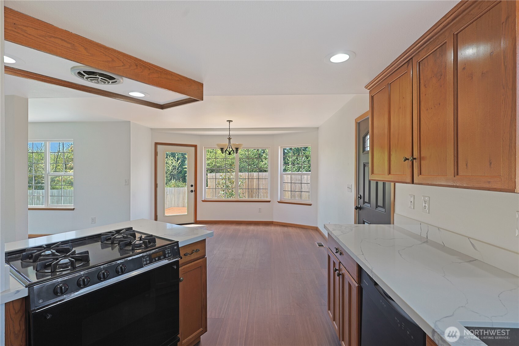 3618 Chrisella Road East Edgewood, WA 98371 - Photo 9 of 33 a kitchen with a stove a sink and wooden cabinets