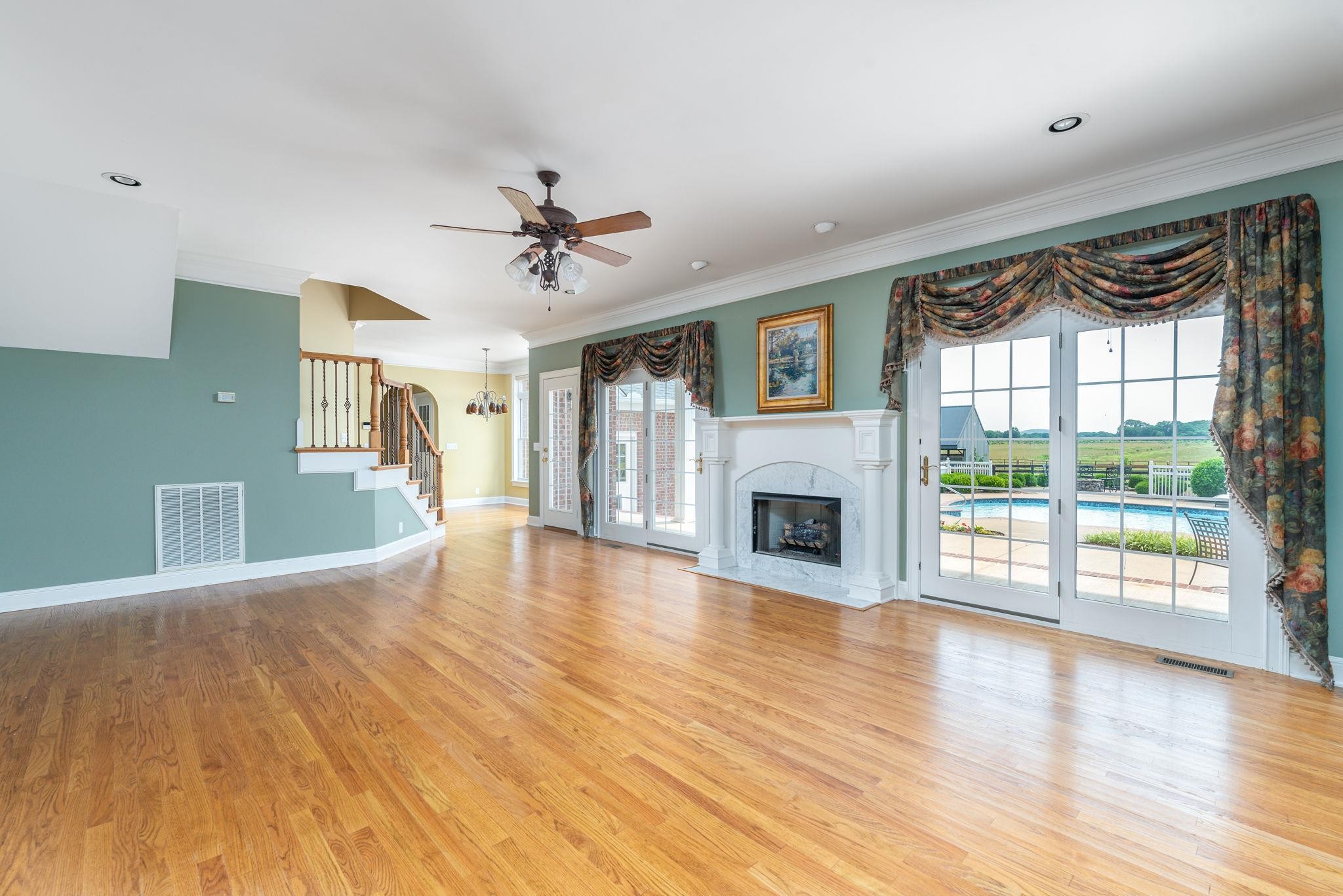 6464 Lebanon Road Murfreesboro, TN 37129 - Photo 11 of 30 a view of a livingroom with wooden floor a fireplace and windows
