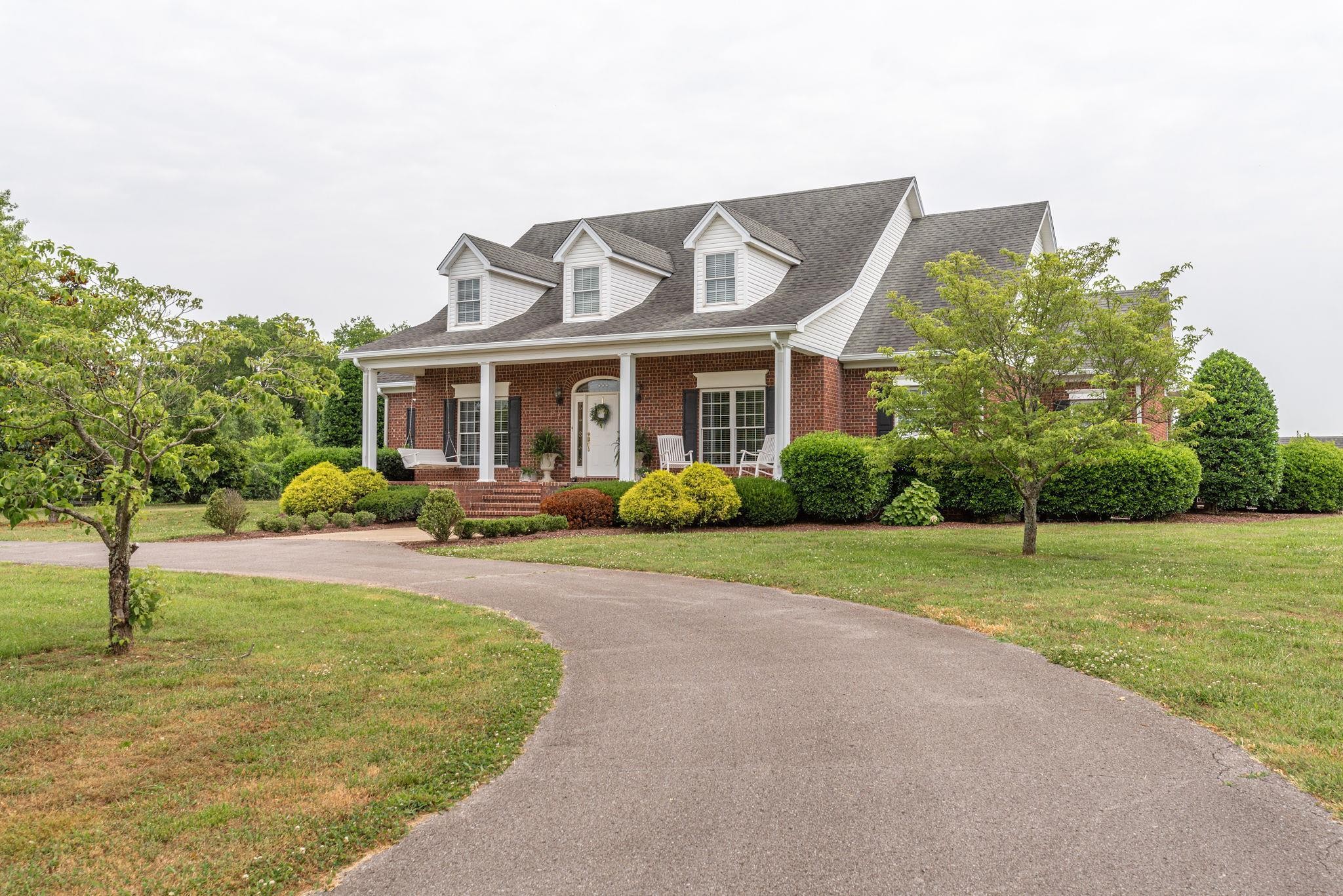 6464 Lebanon Road Murfreesboro, TN 37129 - Photo 2 of 30 a front view of a house with a yard and trees