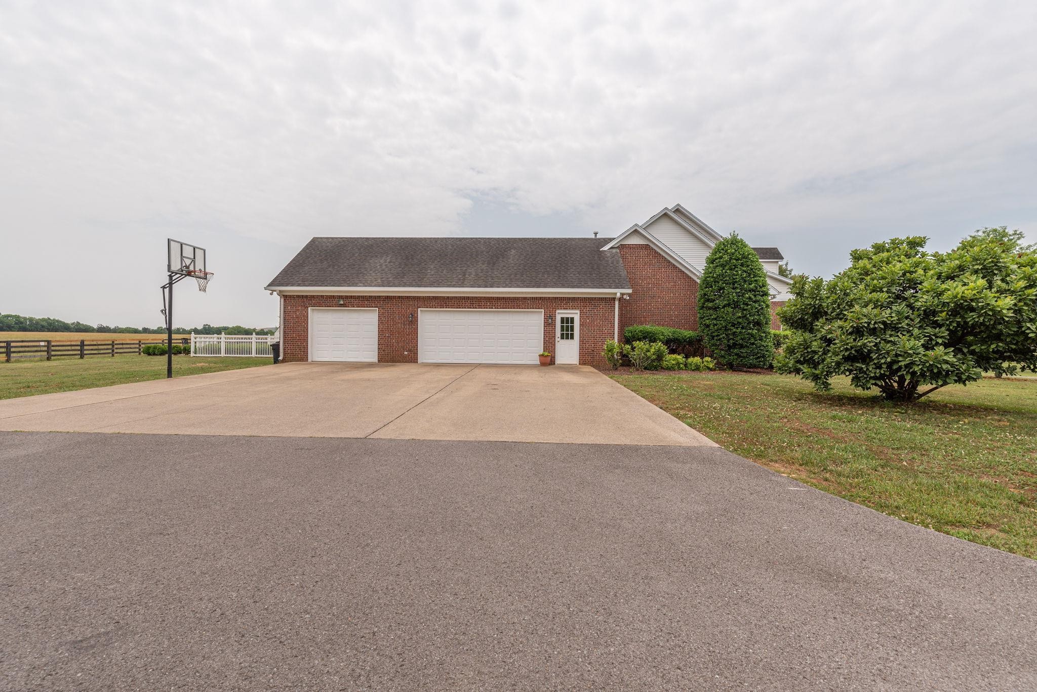 6464 Lebanon Road Murfreesboro, TN 37129 - Photo 3 of 30 a front view of a house with a yard and garage