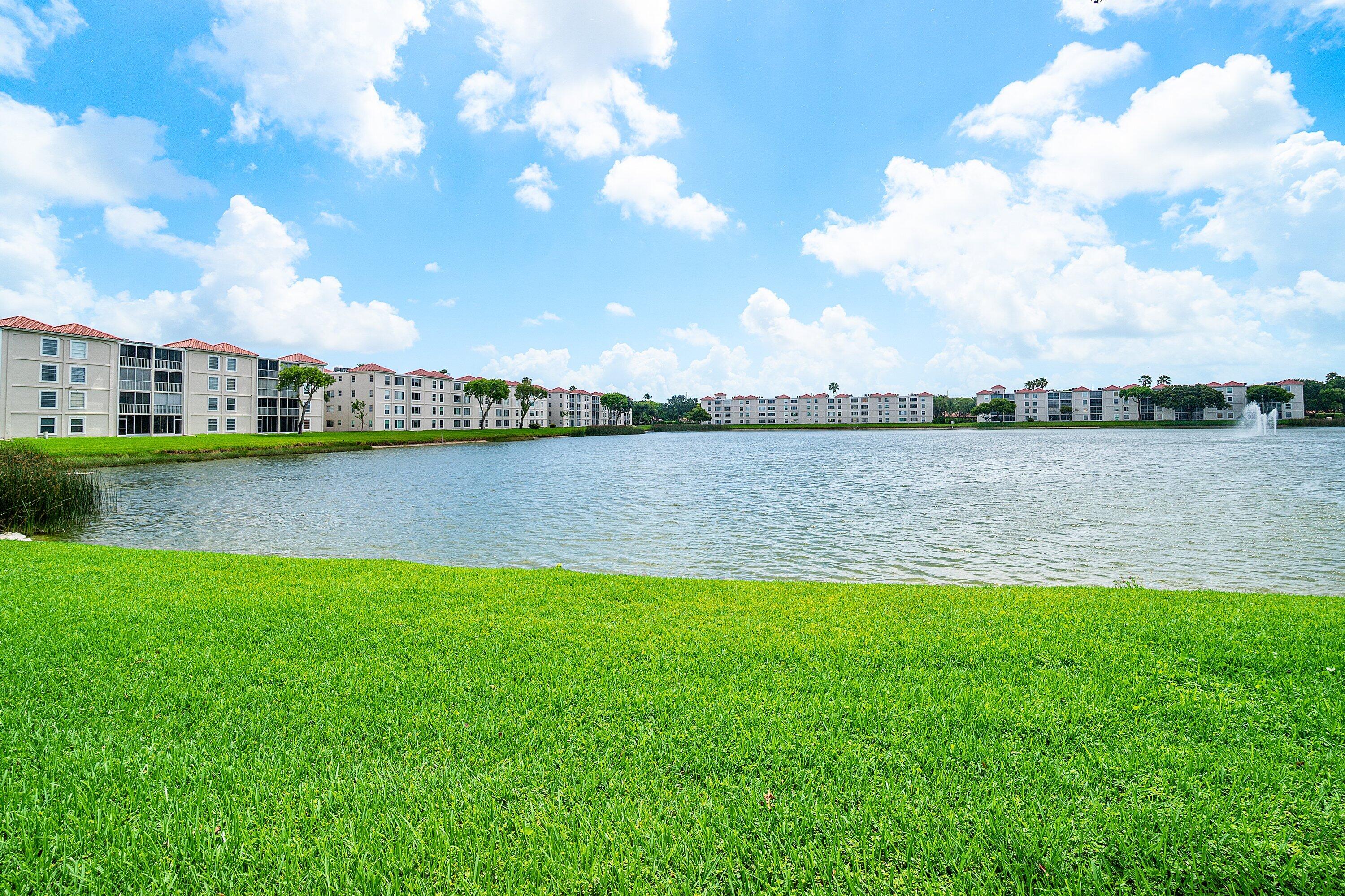 14096 Huntington Pointe Drive, Unit 106 Delray Beach, FL 33484 - Photo 45 of 47 a view of a lake with houses in the back