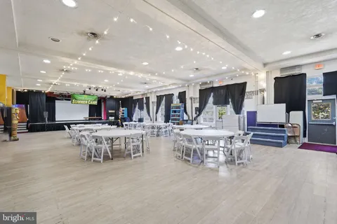 a large kitchen with a table and chairs