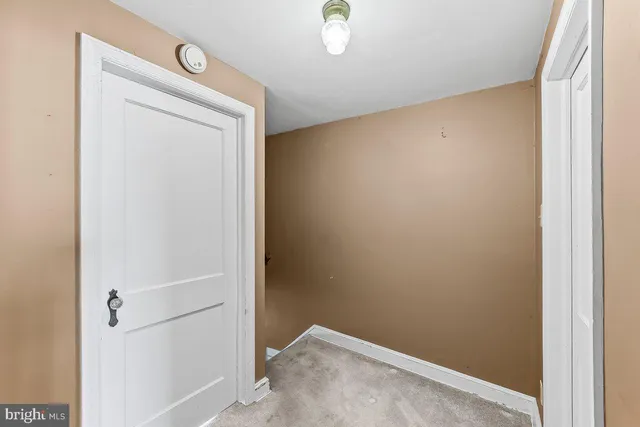 a view of a hallway with bathroom and a bathroom