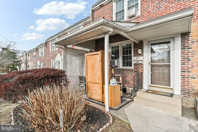a view of a house with a large window and wooden fence
