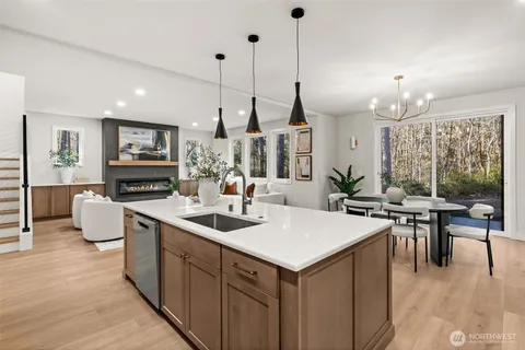 a view of kitchen island dining room living room furniture and a chandelier