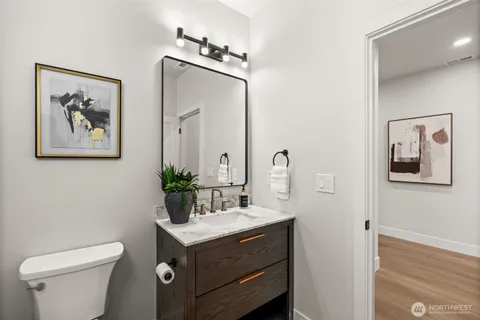 a bathroom with a toilet a sink and mirror
