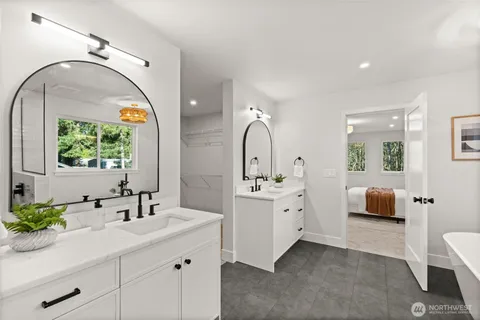 a en suite bathroom with a double vanity sink and a mirror