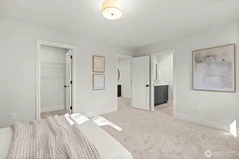 a spacious bedroom with a bed and a shower