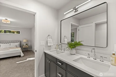 a bathroom with a double vanity sink and a mirror