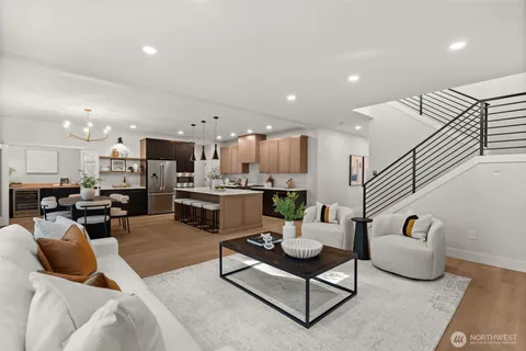 a living room with furniture kitchen view and a dining table