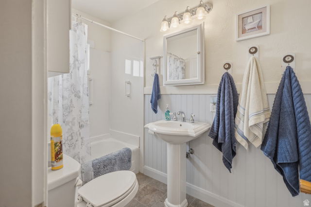 82 South 100 West Lyman, UT 84749 - Photo 16 of 27 Bathroom featuring shower / bathtub combination with curtain and wainscoting