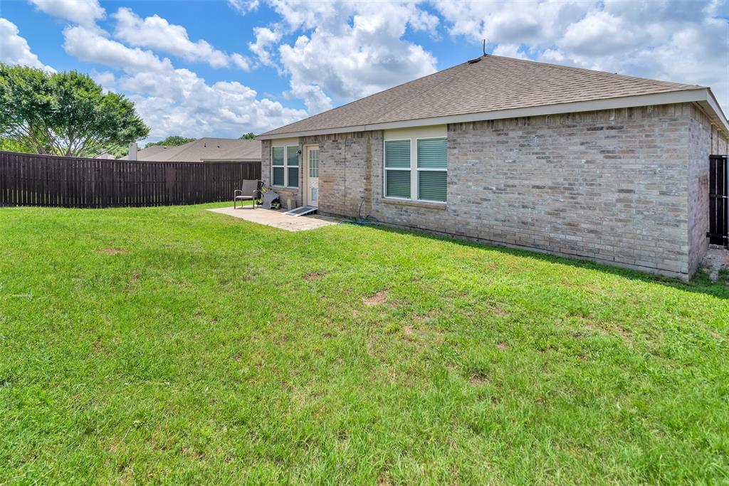 3011 Hickory Ridge Melissa, TX 75454 - Photo 25 of 30 Expansive backyard featuring a manicured lawn, full privacy fencing, a concrete patio, and a brick exterior facade