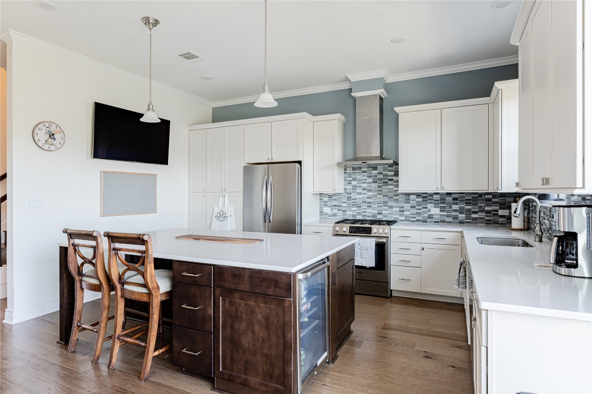 329 Adams Street Georgetown, TX 78628 - Photo 12 of 34 a kitchen with a stove a sink and a refrigerator