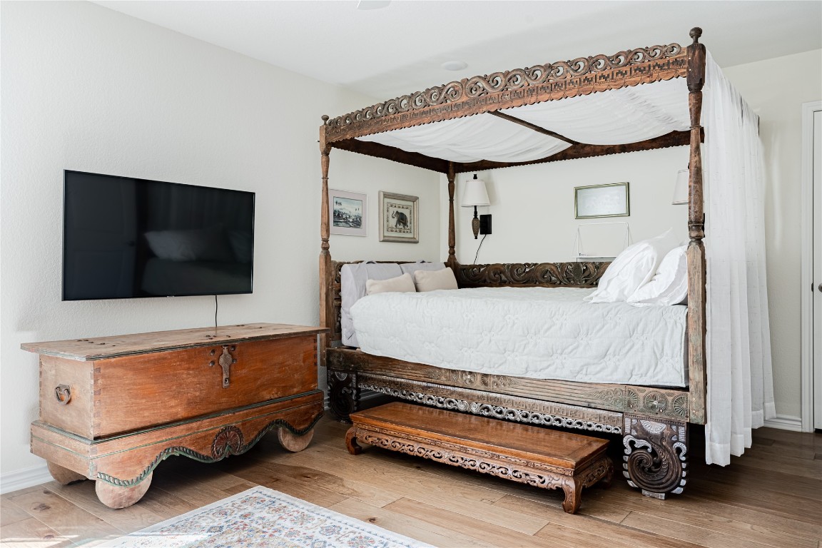 329 Adams Street Georgetown, TX 78628 - Photo 15 of 34 a bedroom with a bed and a flat screen tv