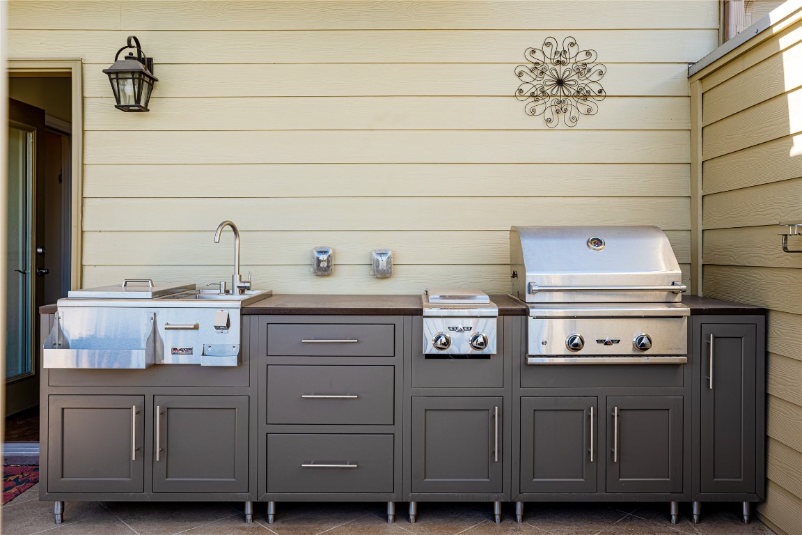 329 Adams Street Georgetown, TX 78628 - Photo 29 of 34 a kitchen with a cabinets and a stove with a sink