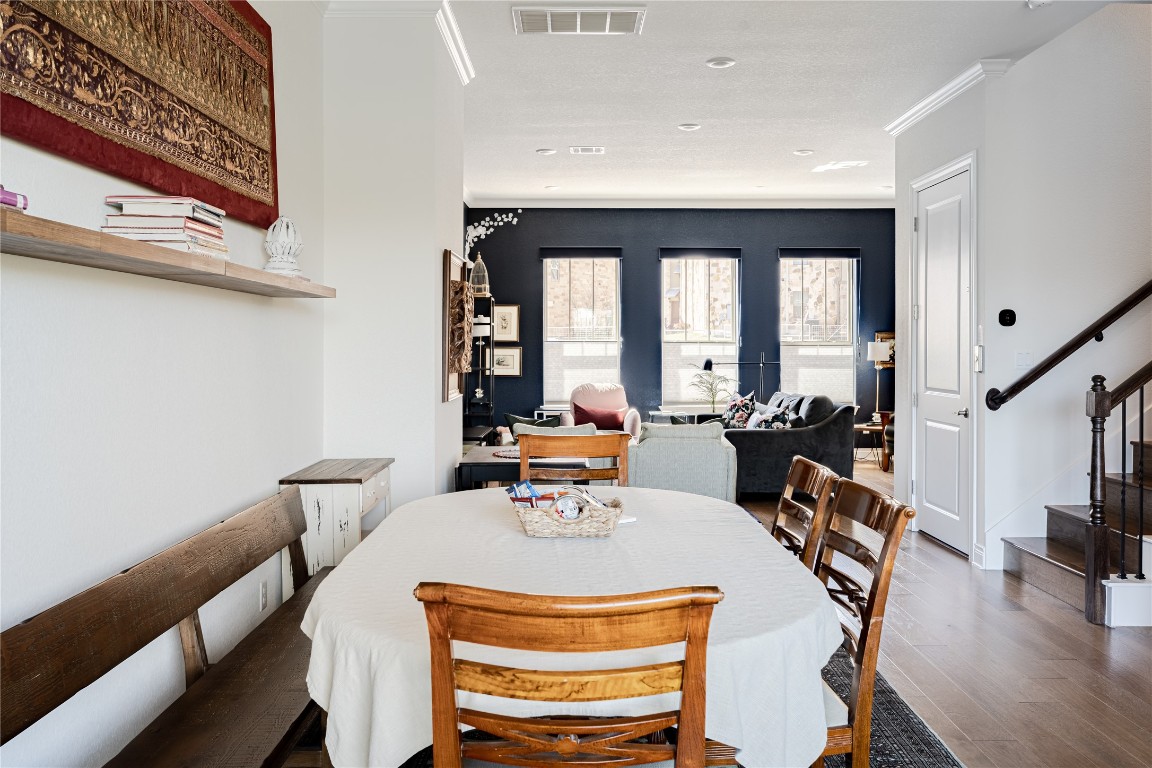 329 Adams Street Georgetown, TX 78628 - Photo 7 of 34 a view of a dining room with furniture a chandelier and wooden floor