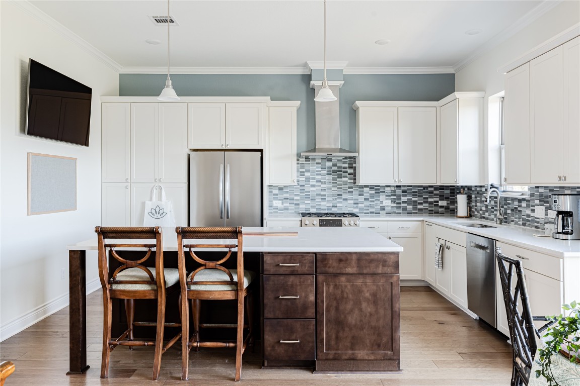 329 Adams Street Georgetown, TX 78628 - Photo 9 of 34 a kitchen with stainless steel appliances granite countertop a table chairs sink and cabinets