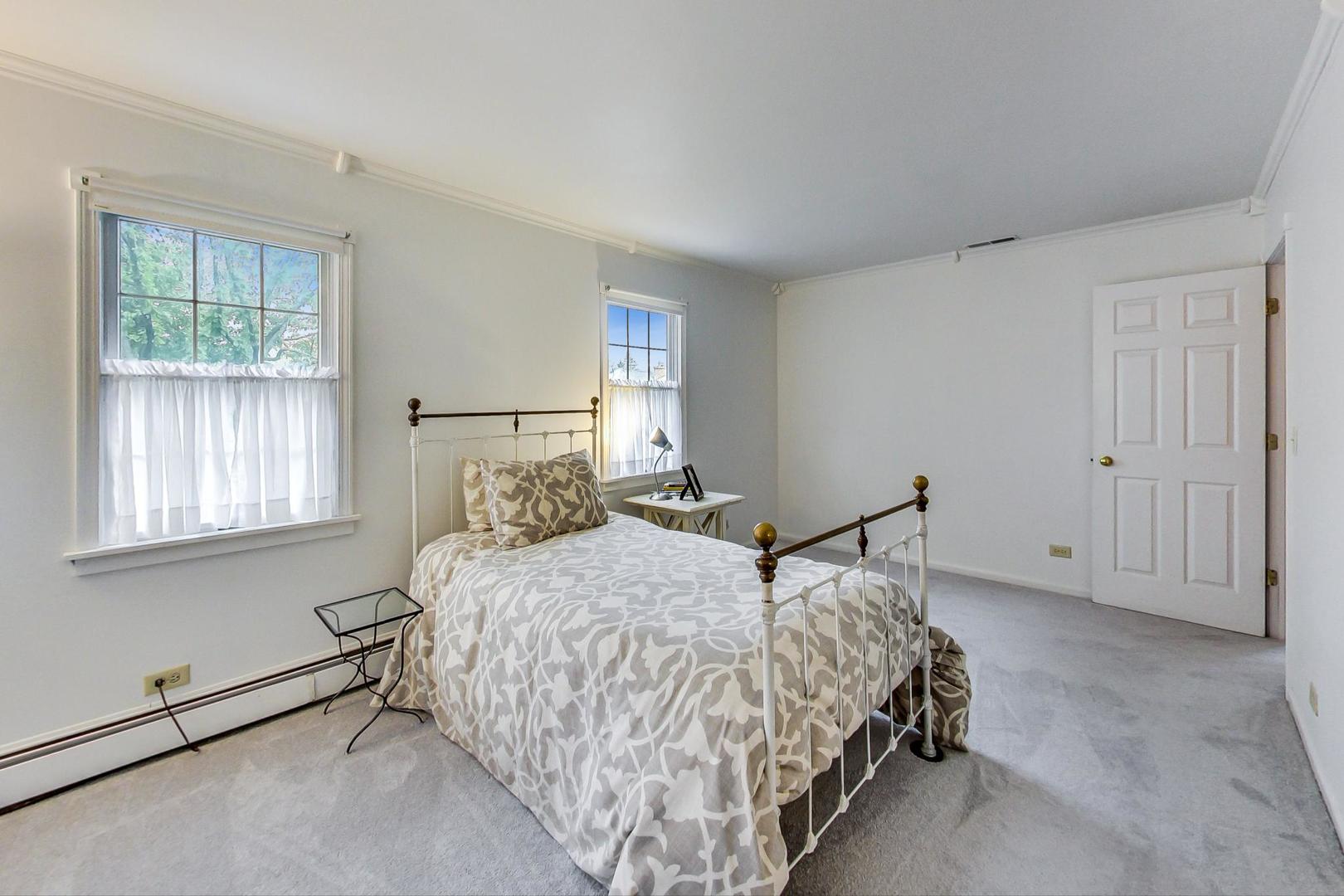 583 North Happ Road Northfield, IL 60093 - Photo 40 of 63 a bedroom with a bed and two windows