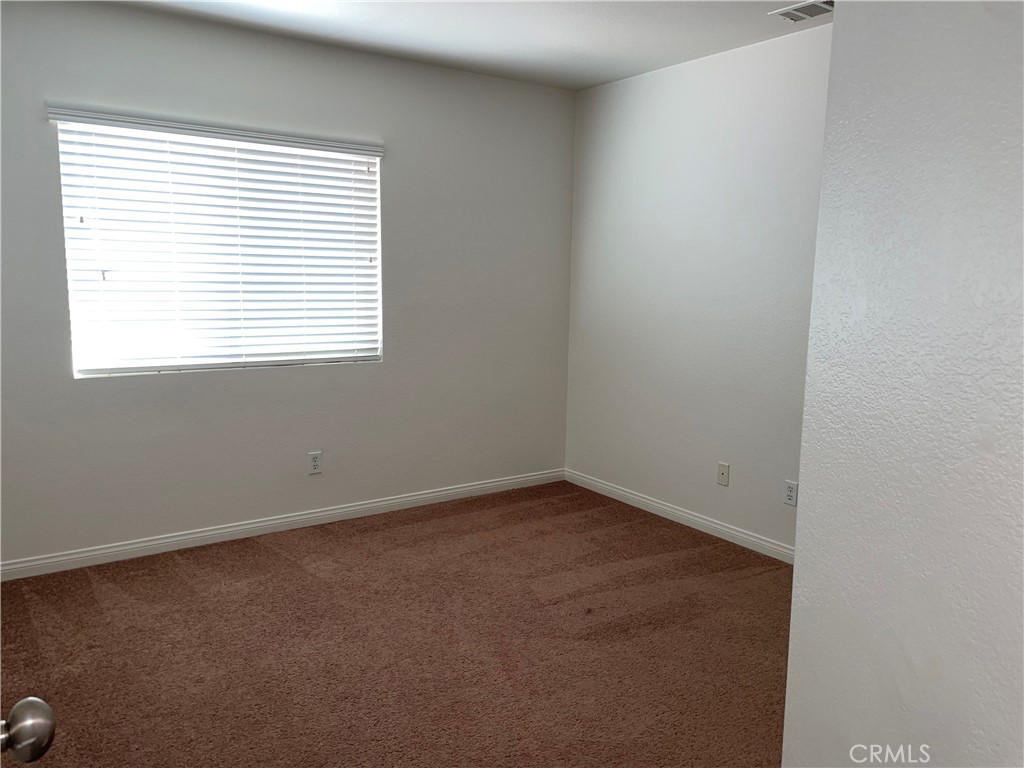 12661 Luna Road Victorville, CA 92392 - Photo 17 of 20 an empty room with a window