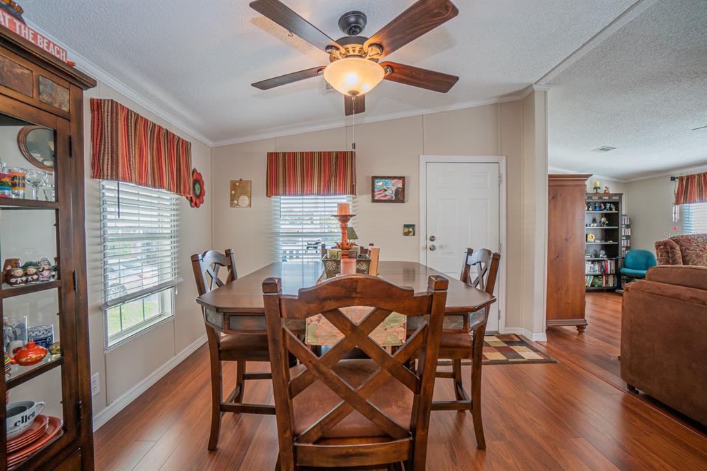 10303 Burnt Store Road, Unit 203 Punta Gorda, FL 33950 - Photo 11 of 41 a view of a dining room with furniture and wooden floor