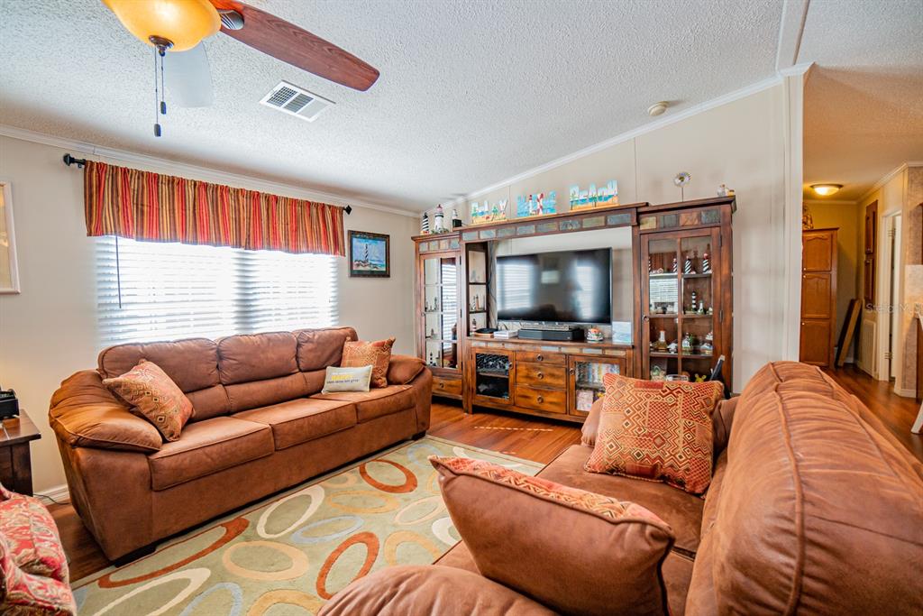 10303 Burnt Store Road, Unit 203 Punta Gorda, FL 33950 - Photo 16 of 41 a living room with furniture and a flat screen tv